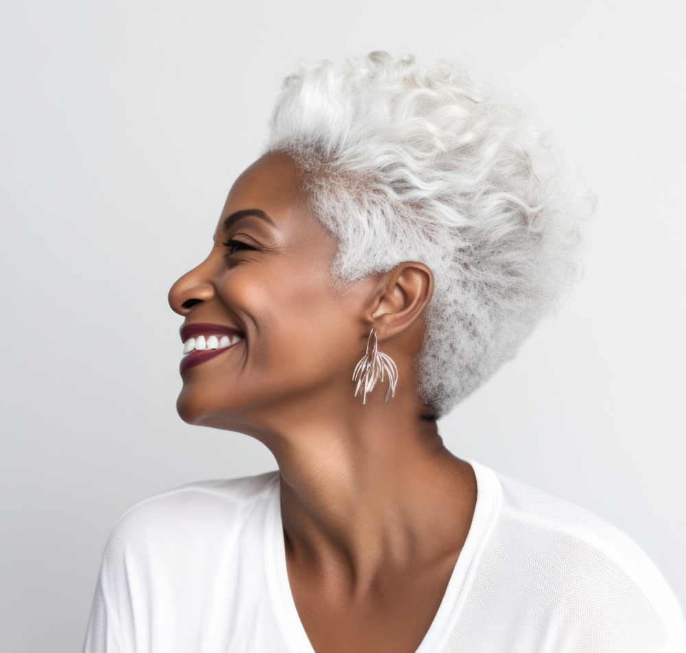 Confident woman smiling, embracing aging and wrinkles gracefully.