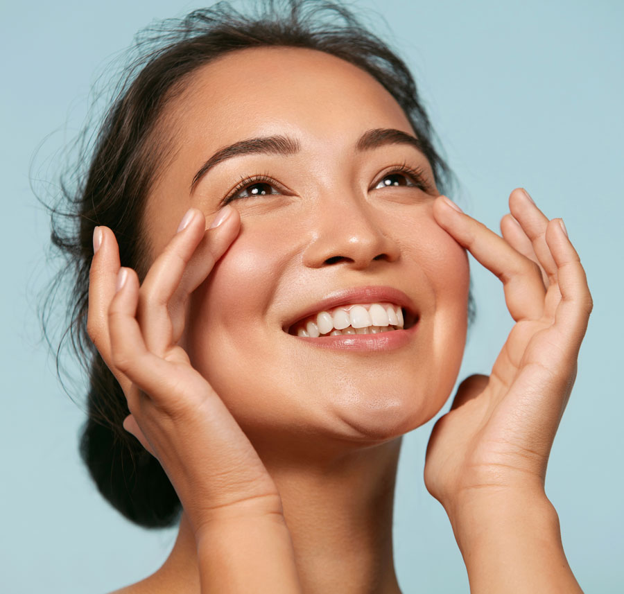Woman with glowing skin smiling after Hydrafacial.
