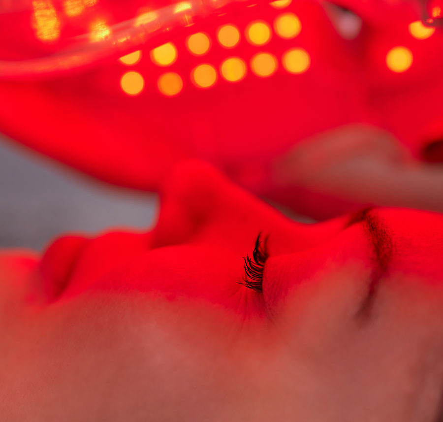 Woman receiving red light therapy for loss of elasticity and sagging skin.