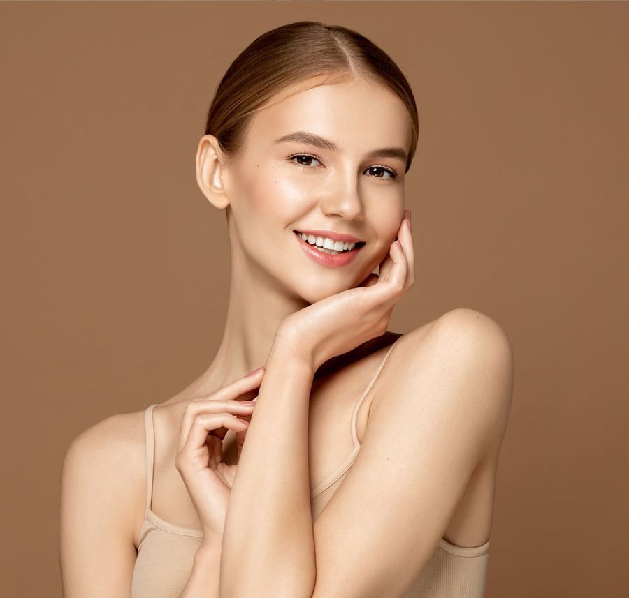Woman smiling with glowing skin after microdermabrasion.