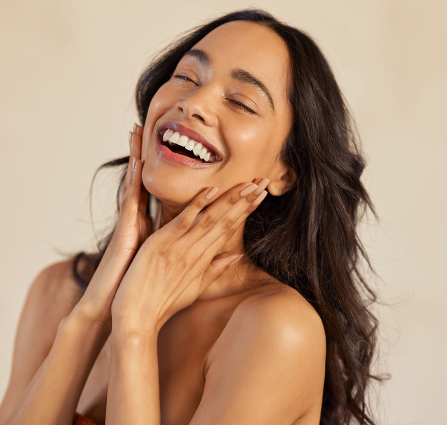 A radiant woman with glowing skin after a Nano-Needling Facial, showcasing its rejuvenating effects.