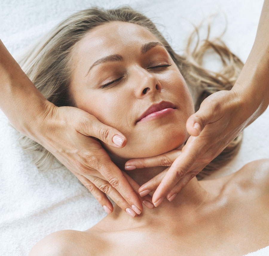 A relaxing Rich-Girl Skin Facial session with a professional esthetician gently massaging a client's face.