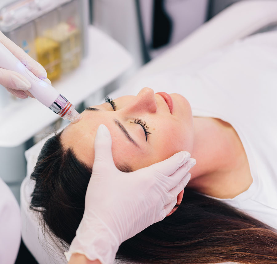 A woman receiving a skin rejuvenation and overall glow facial treatment with a hydrafacial device.