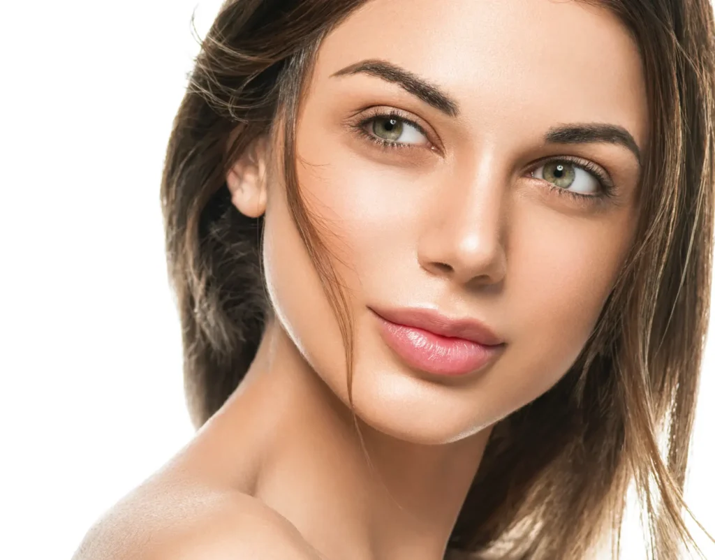 Close-up portrait of a woman with smooth skin and natural makeup against a white background